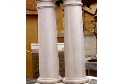 Two soft maple Tuscan wood columns with a capital and base, showcasing custom architectural detailing.