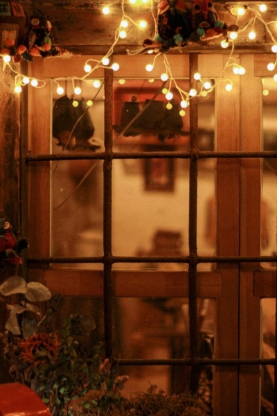 String lights draped over a window as fall decor