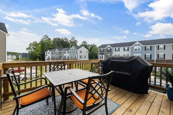 An outdoor deck made of wood in a home complex.